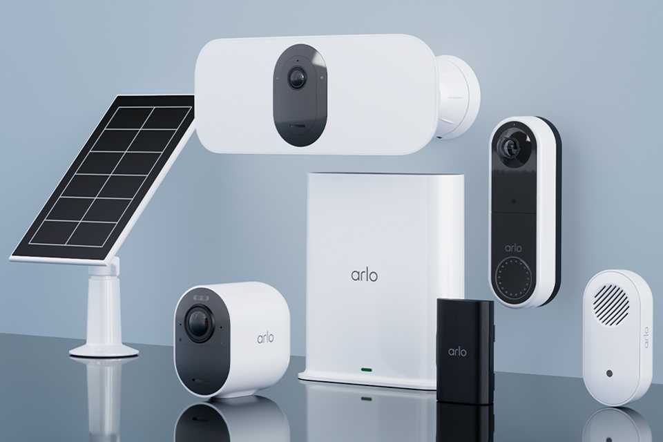 An assortment of Arlo home security products against a grey background.
