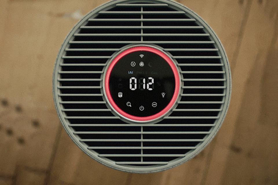 A close-up of a Philips air purifer's circular digital display, with a red glowing ring of light around the edge and numbers at the centre.