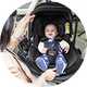 A baby in a Joie Signature i-Level Pro Deep Recline Car Seat - Eclipse.