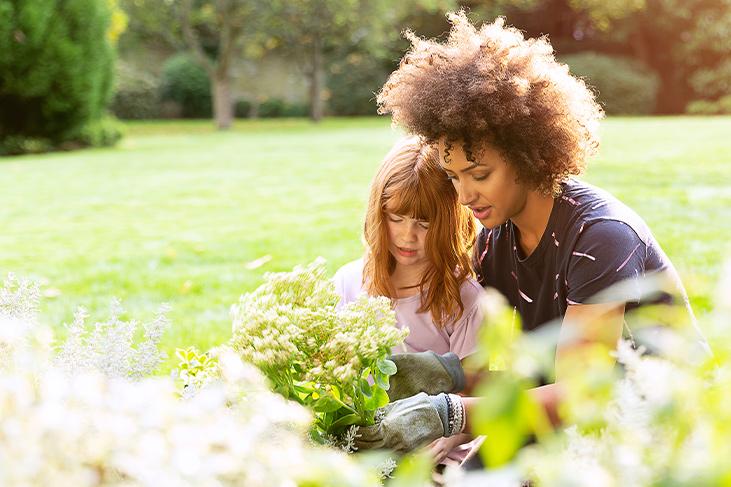 Mother and daughter doing some gardening in the sunshine.