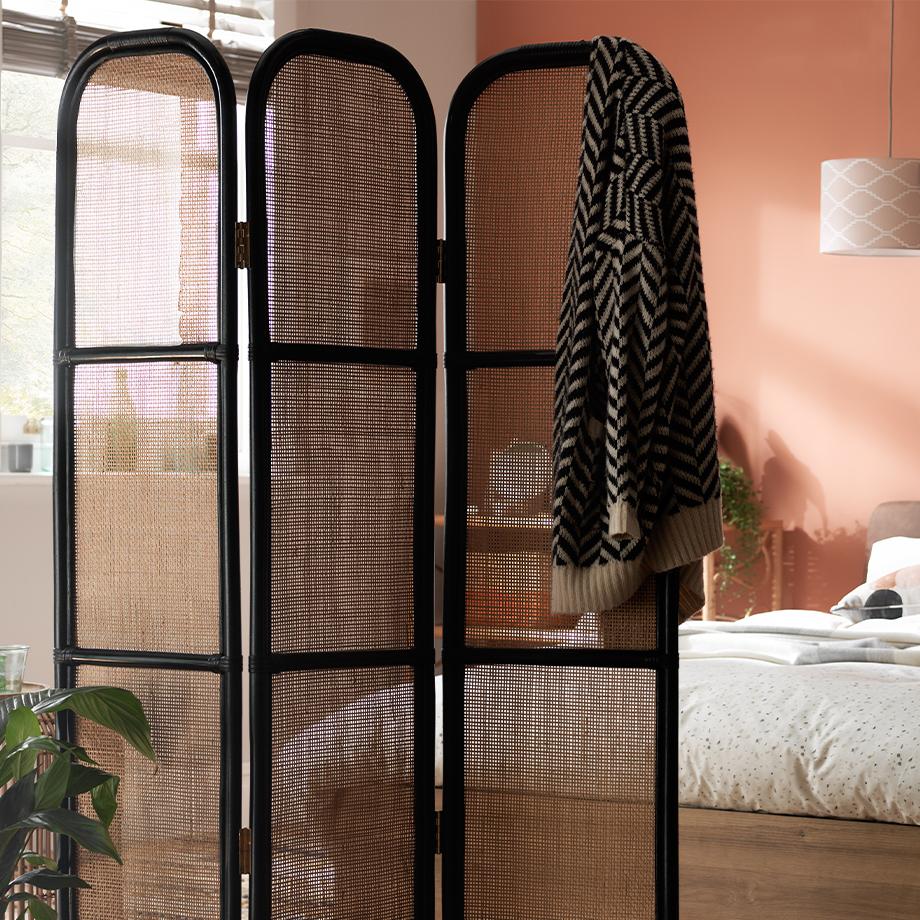 Black screen used as a room divider.