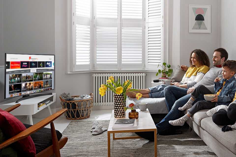 A family exploring their favourite series and shows on their Freeview Play television.