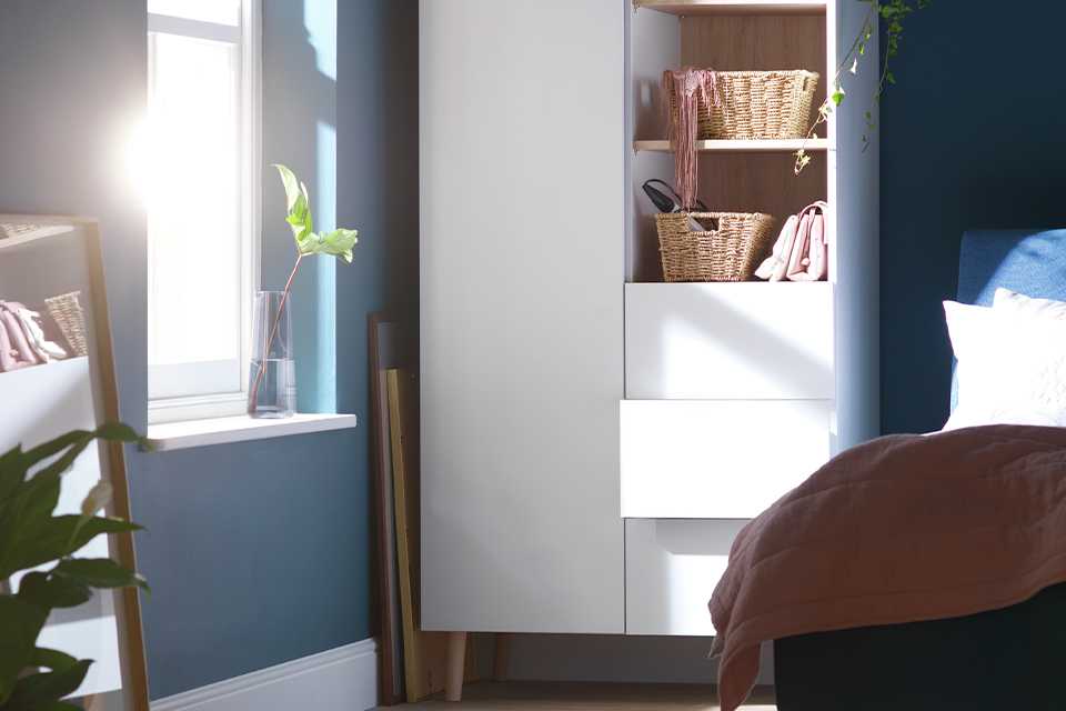 White double door wardrobe with drawers in bedroom.