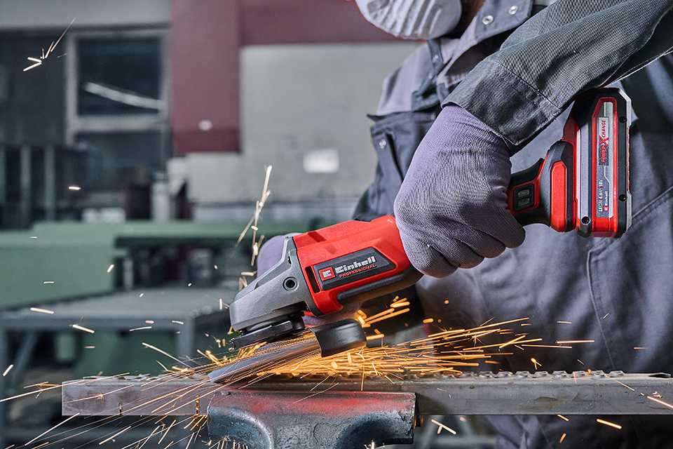 An Einhell cordless angle grinder in use.
