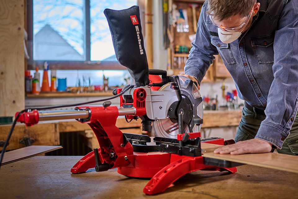 A man using Einhell saw against a wooden board.
