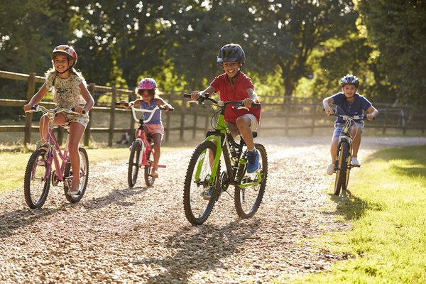A group of kids riding bikes outdoors.