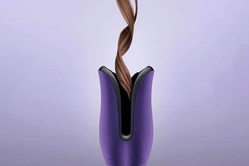 A section of hair curled using the purple Glamoriser Instant Auto Curler.
