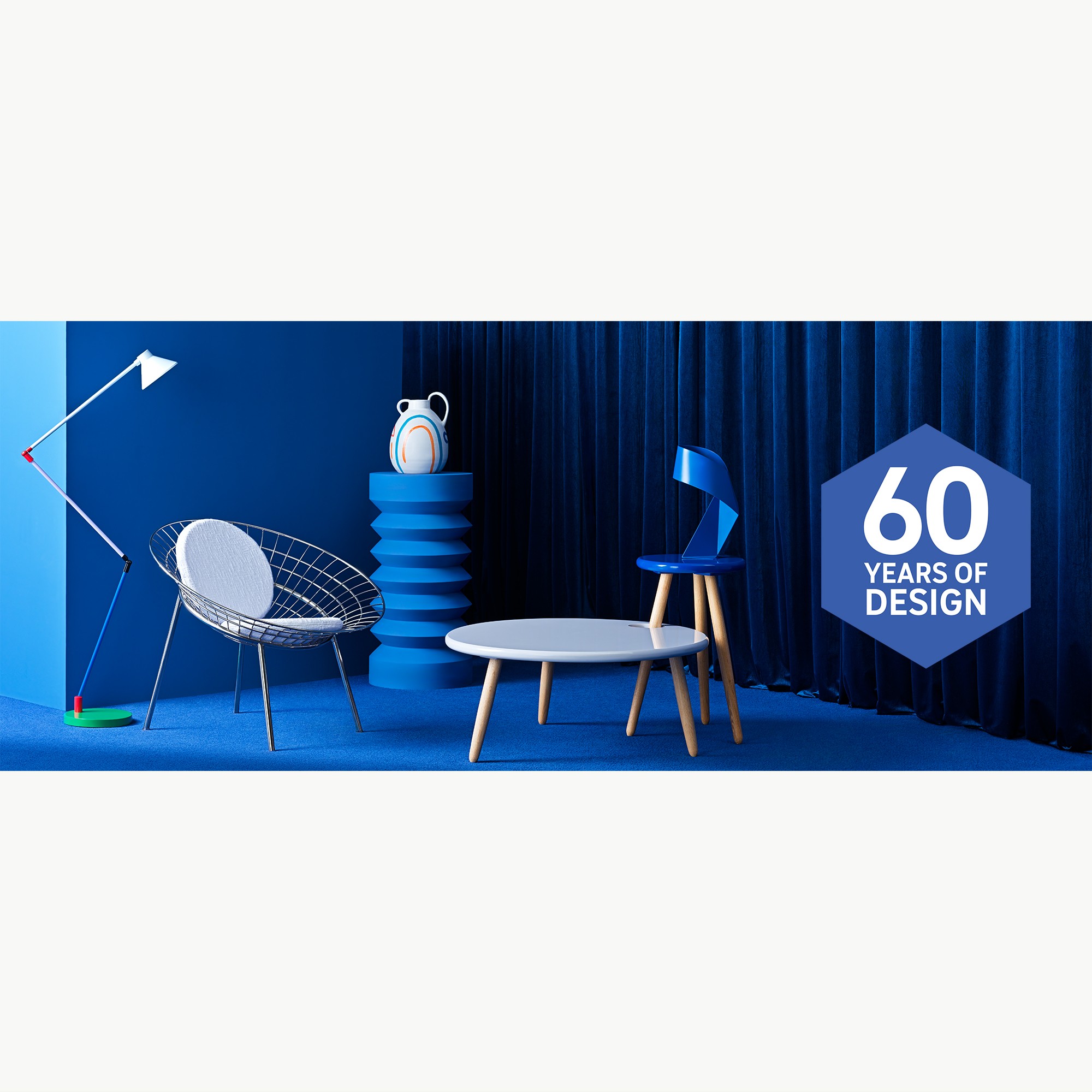 Habitat 60th collection lighting in front of blue background.