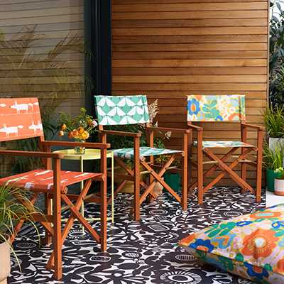 Scion directors chairs in garden with bright and bold patterns.