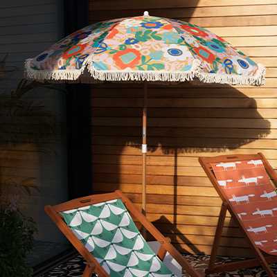Scion tassle outdoor umbrella with garden chair.