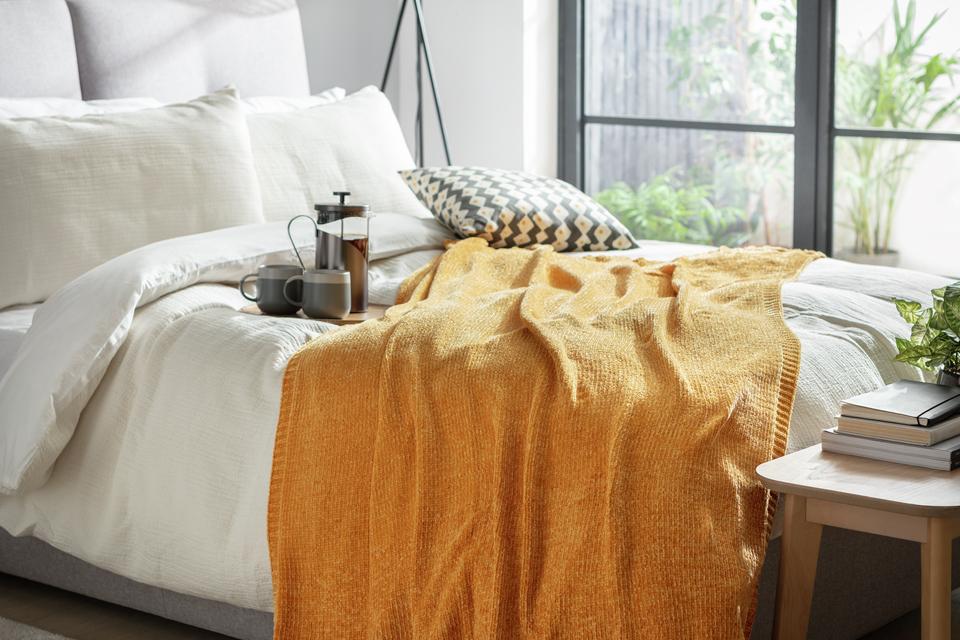 Habitat Chenille throw in gold colour.