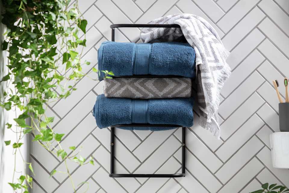 3 Towels on a Habitat Matte Black Wall Mountable Towel Holder.