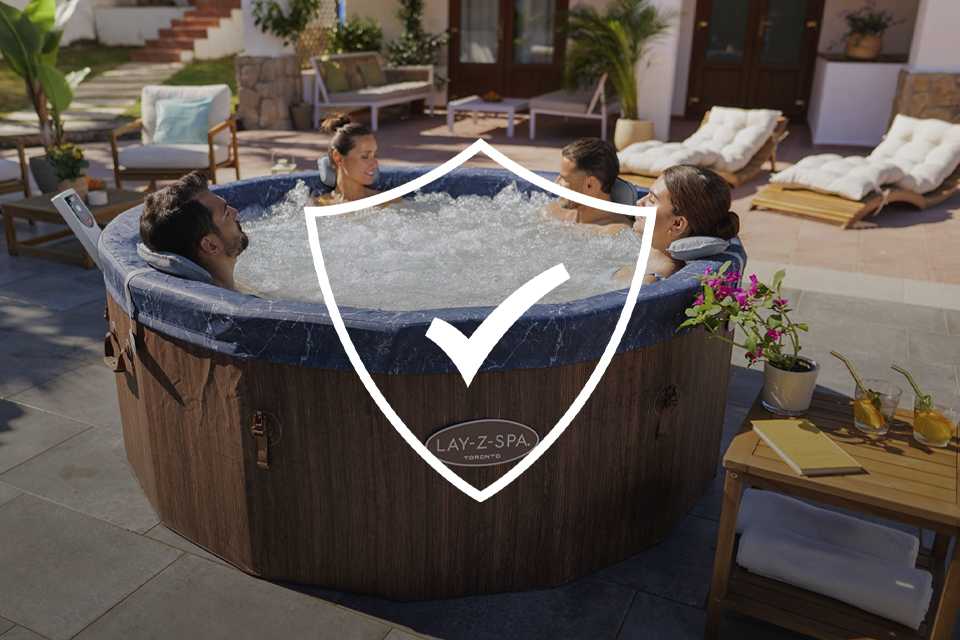 A couple covering a hot tub using Lay-Z-Spa Thermal Cover 71 x 71 x 28cm in grey colour.