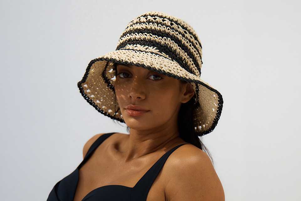 A woman wearing Mono Straw Cloche Hat.