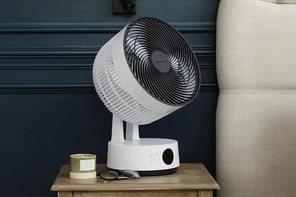 10 inch Meaco Sefte White Desk Fan placed on a bedside table.