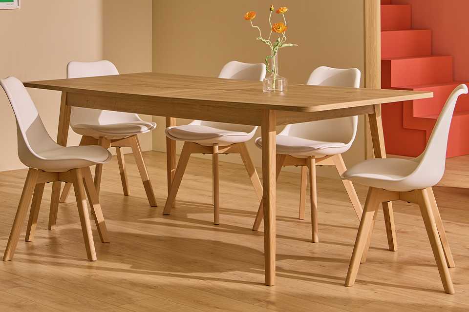 A Habitat Sylas extending 6 seater dining table in wood-effect in a dining room.