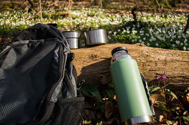 Green flask with backpack