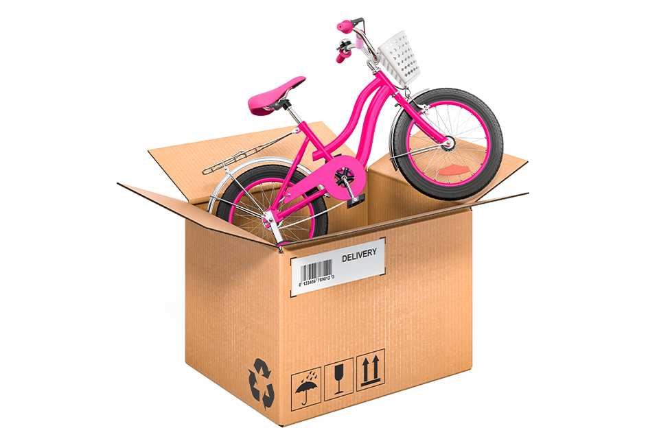 A delivery box with a pink bike in it.