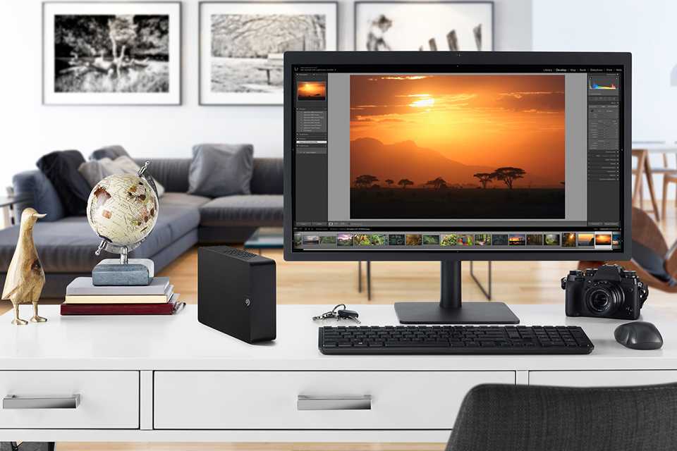 A portable hard drive connected to a computer.