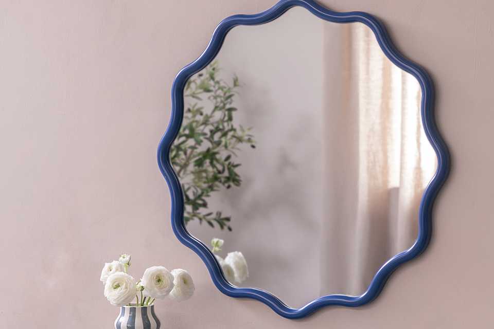 : A Habitat blue wavy round wall mirror.