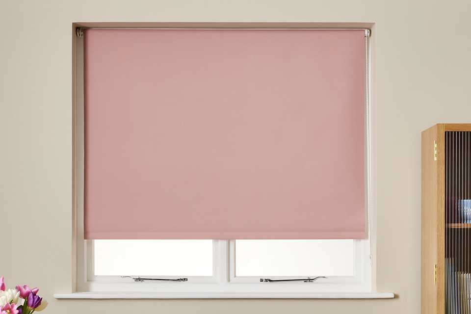 A Habitat blackout blush roller blind.