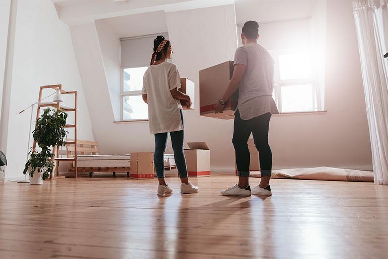 Young couple moving in new house.