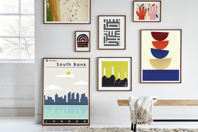 Several differently sized prints hanging on a wall.