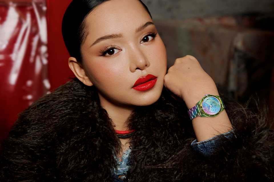 A female model wearing a Hugo women's multicolour stainless steel bracelet watch.