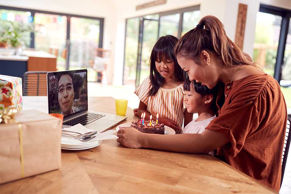 A couple using a laptop connected on TP-link home Wi-fi with their kids taking down some notes.