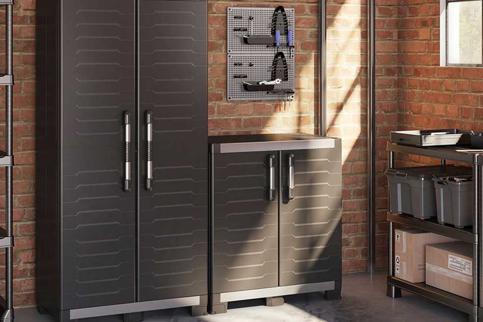 Keter Garage XL Indoor Base storage cabinet in garage with tall Keter storage cabinet next to it.