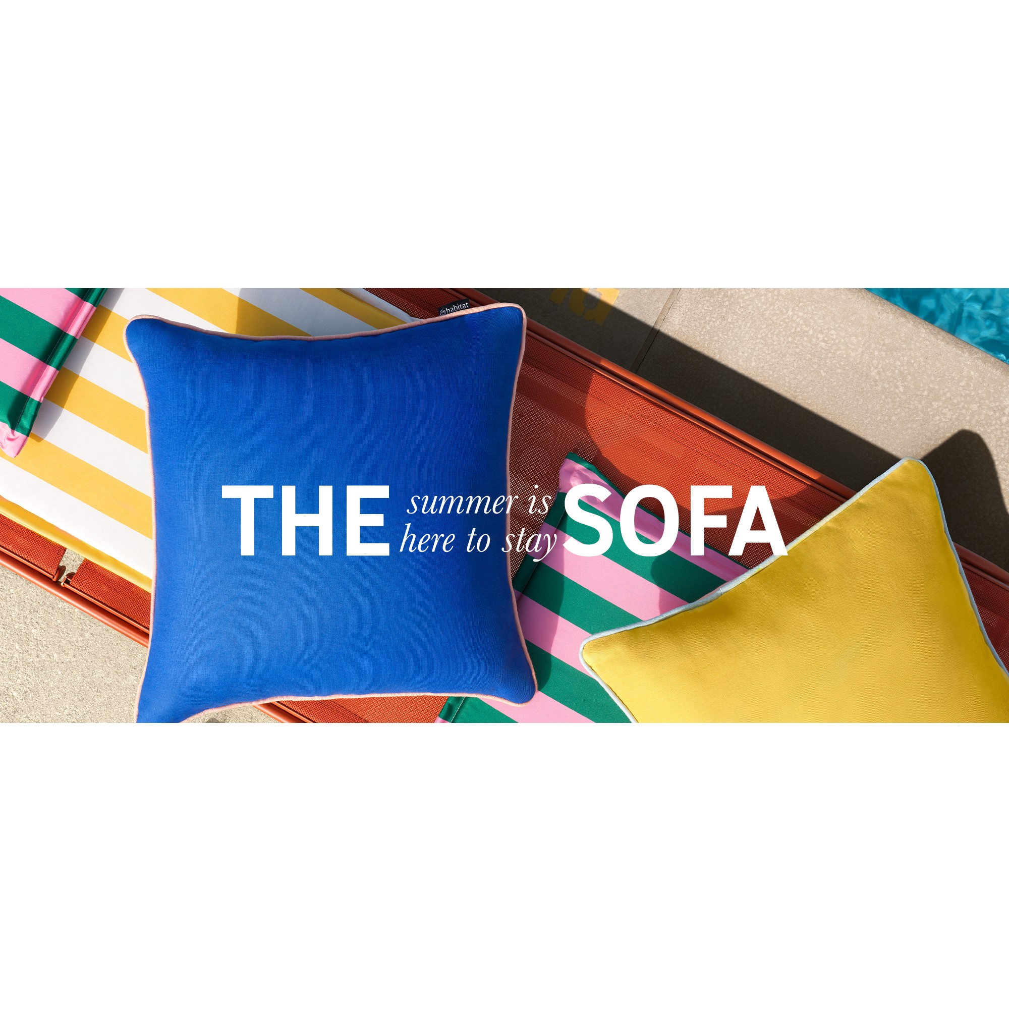 A banner with colourful cushions near a swimming pool saying summer is here to stay.