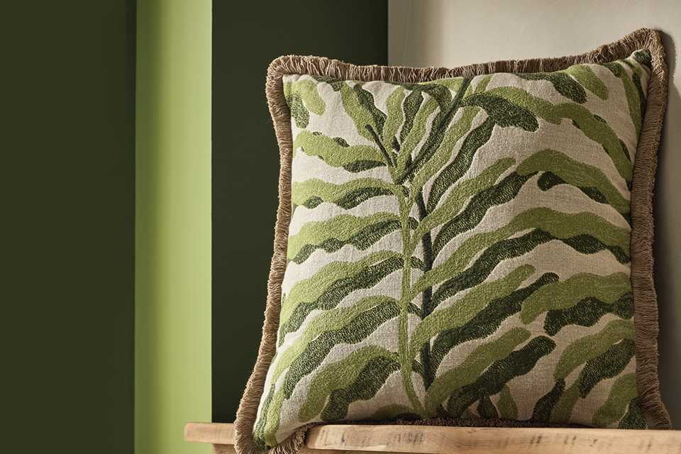 A Habitat leaf green jacquard cushion in a living room.