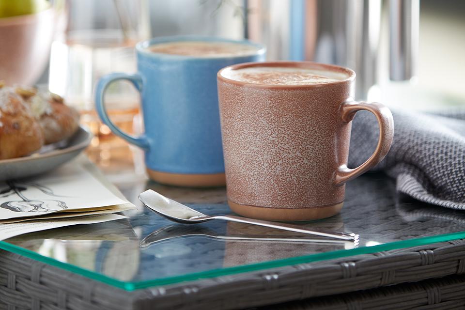 Blue and brown mug fill with coffee.