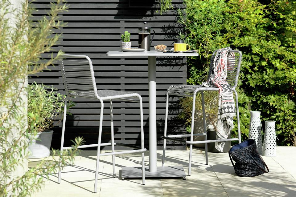 Garden with black fence and grey bar set.