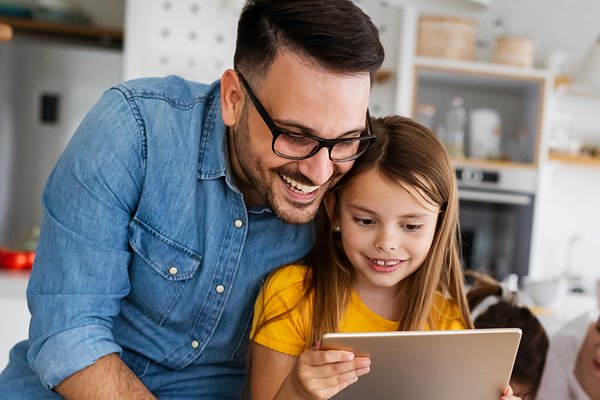 A man and young girl looking at a table.