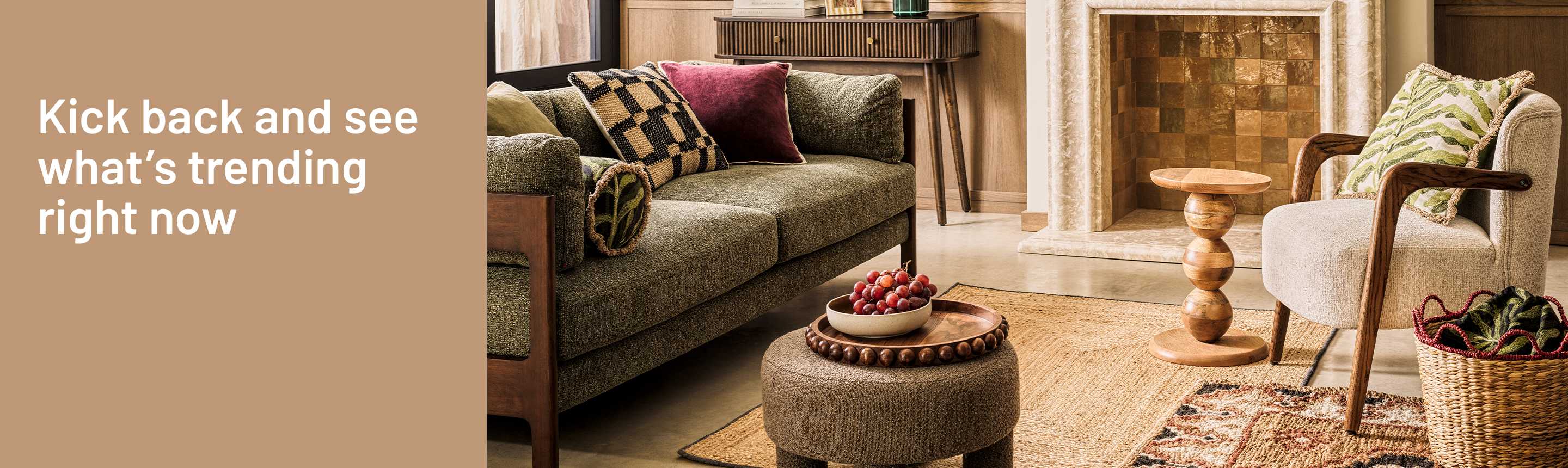 A banner displaying a verde luxe living room decorated with a rug, a sofa with patterned cushions, a coffee table, and a table lamp.