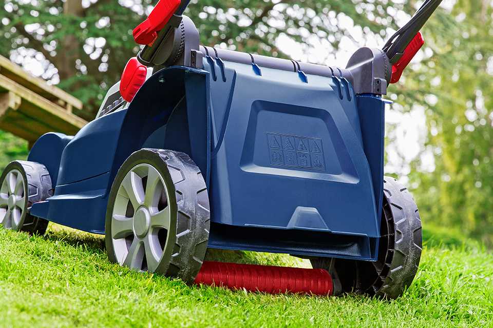 A lawnmower with a rear roller being used on a lawn.