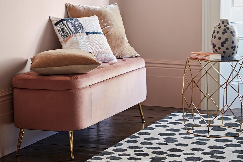 Pink ottoman storage.