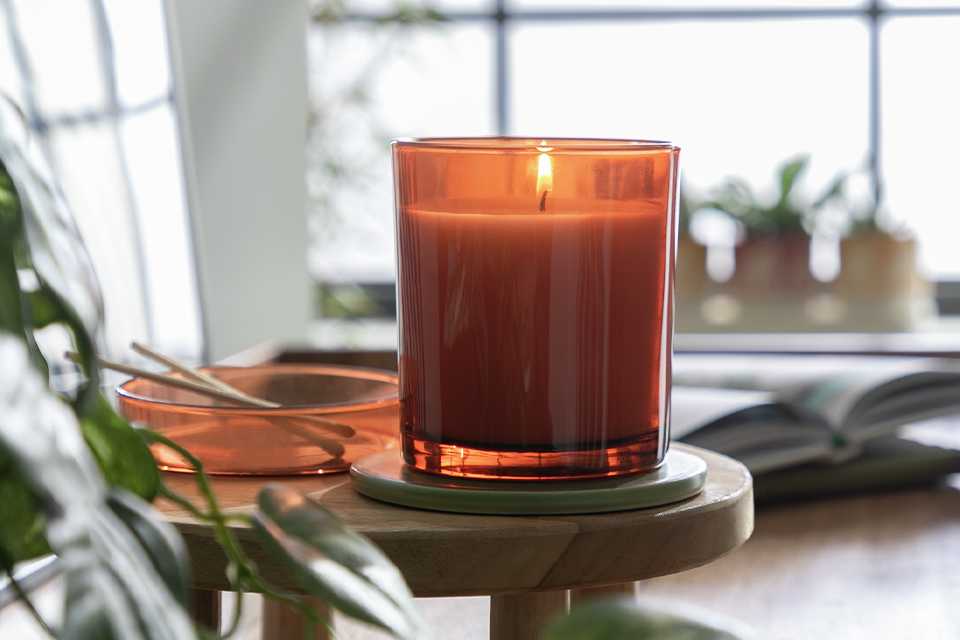 Orange candle on desk.