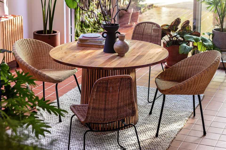 A mango wood round dining table.