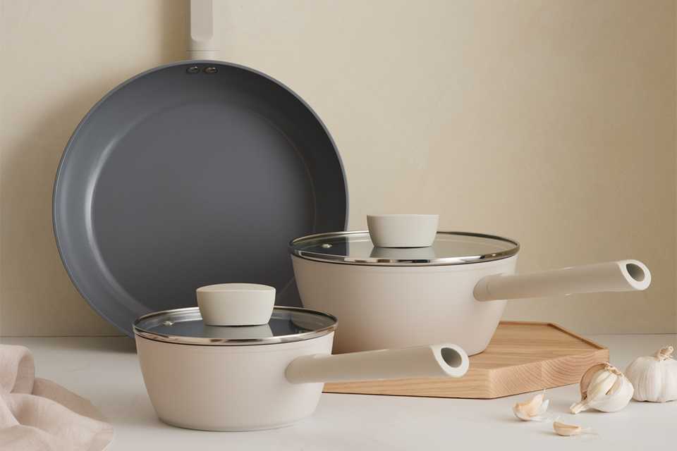A Habitat 3 piece ceramic coated pan set placed on a kitchen counter.