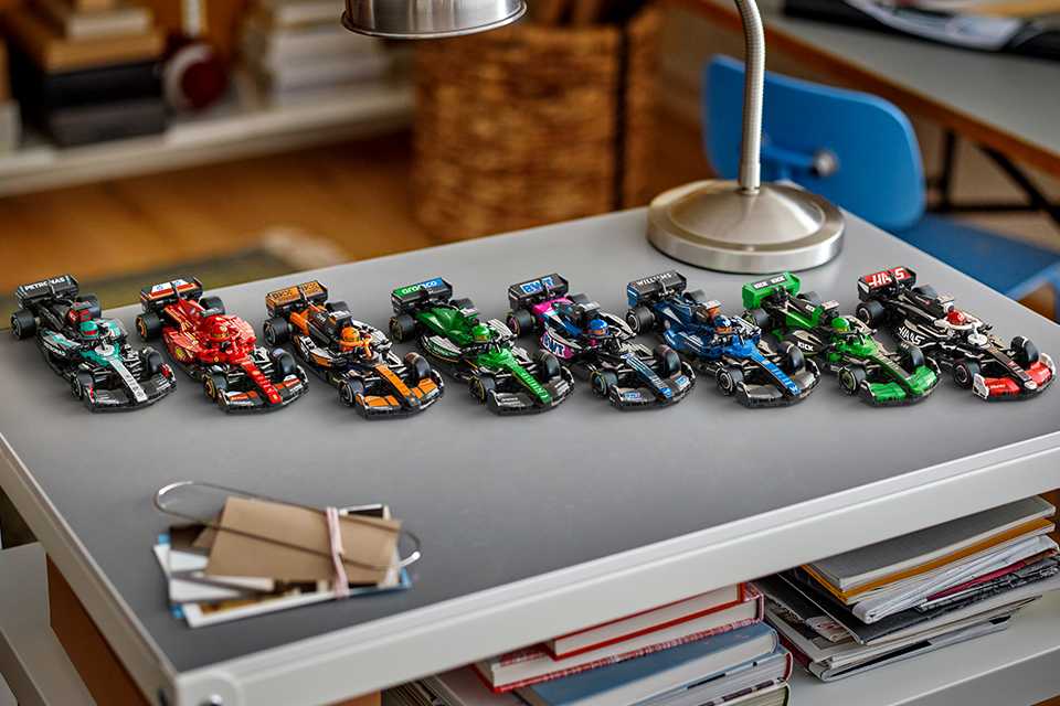 Eight of the new 2025 season Speed Champions Formula 1® team cars lined up on a desk.