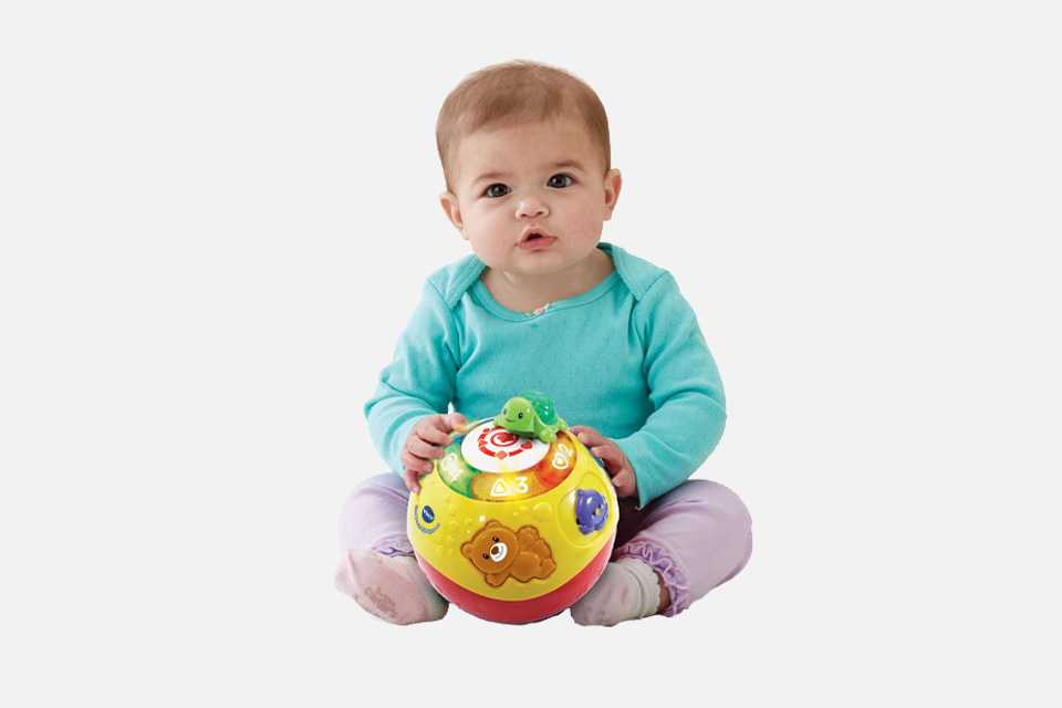 A child playing with a Vtech Crawl 'n' Learn Bright Lights ball.