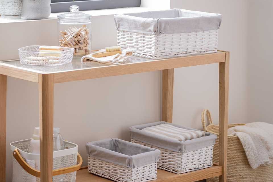 White Habitat pack of 3 wicker storage baskets placed on a shelving unit.