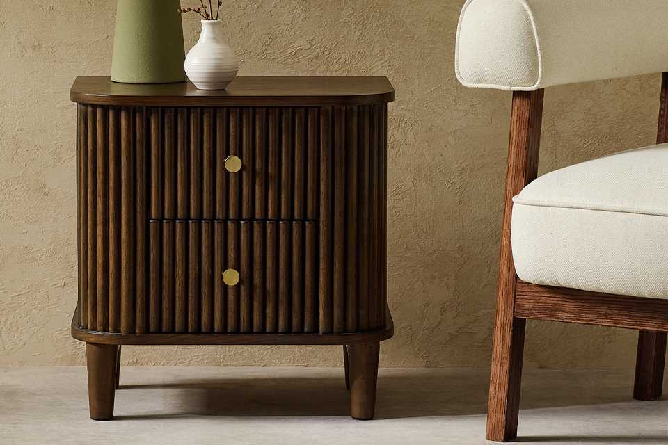 A Habitat Kendi Side Table in a living room next to a white chair.