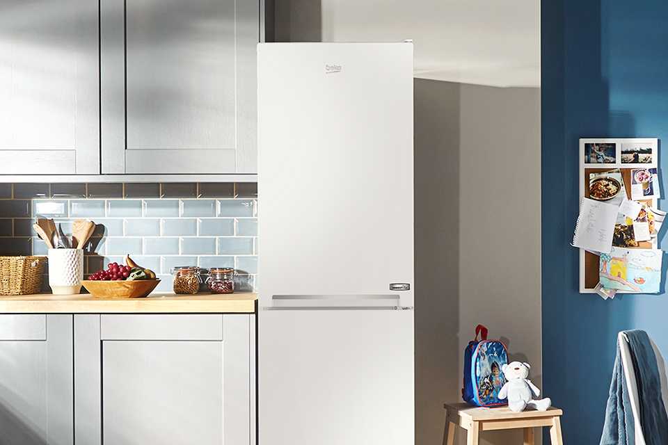 A white Beko fridge freezer in a kitchen enviornment.