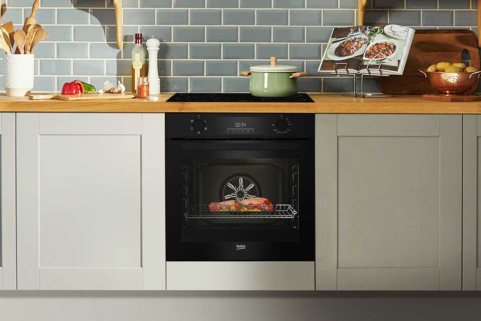 A Beko single oven with food baking inside it.