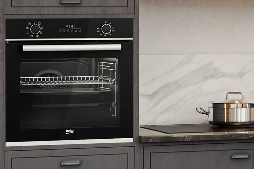 A Beko single oven built-in a greay panelled kitchen.