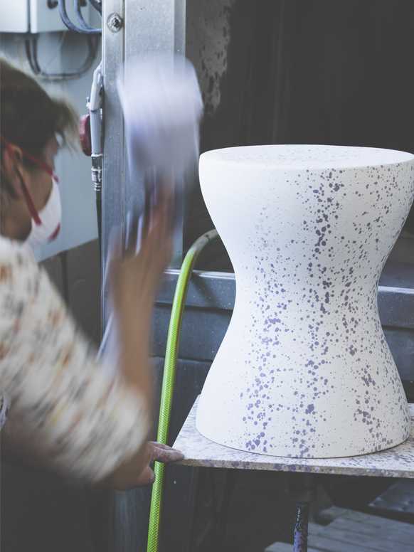 A woman working on Habitat Jackson side table in a factory.