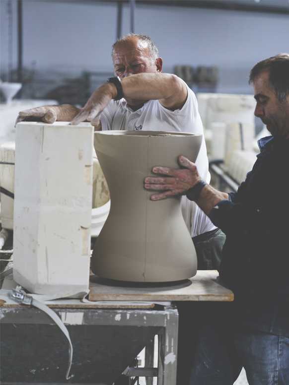 2 men working on Habitat Jackson side table in a factory.